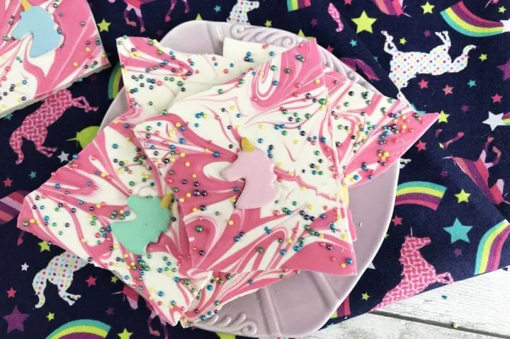 Swirled, pink and white unicorn bark topped with a candy unicorn head. 