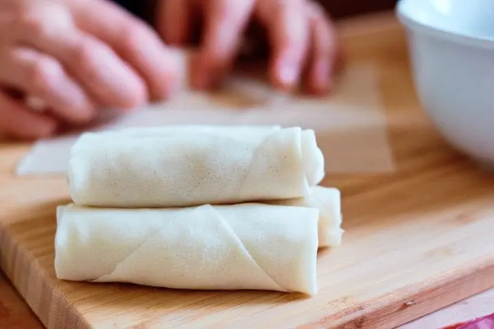 rolling the rice paper wrappers vietnamese cha gio