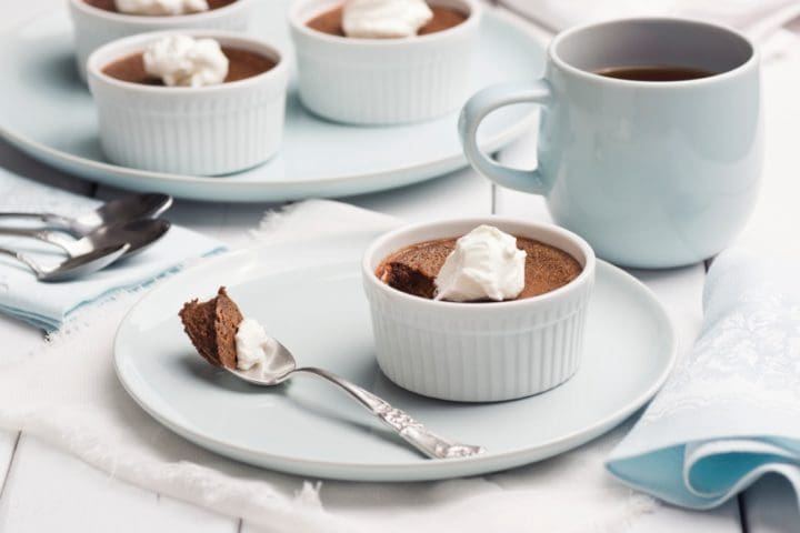 Ramekins of Chocolate Pot De Creme with Whipped Cream and Mug of Coffee