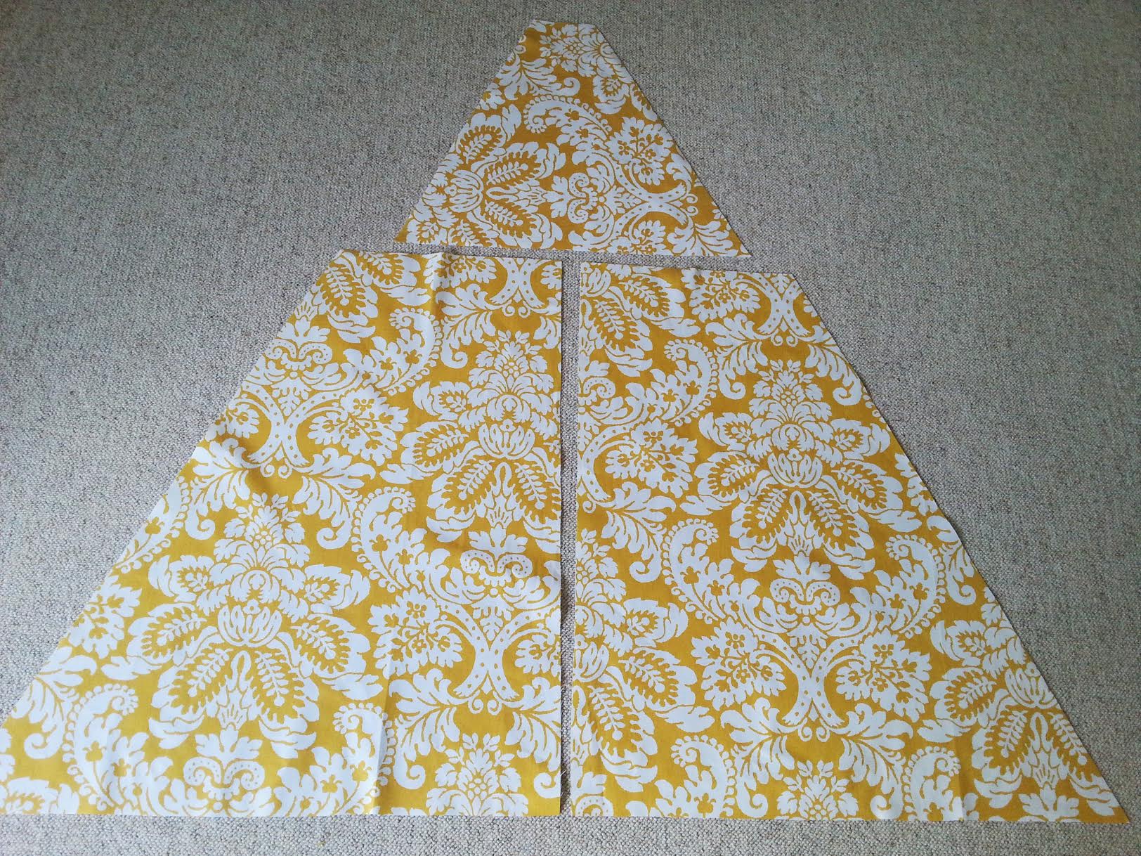 Three fabric pieces cut for the DIY kids teepee tent. sewing pattern for child's teepee