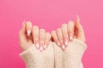 female hands with beautiful long nails with manicure with hear