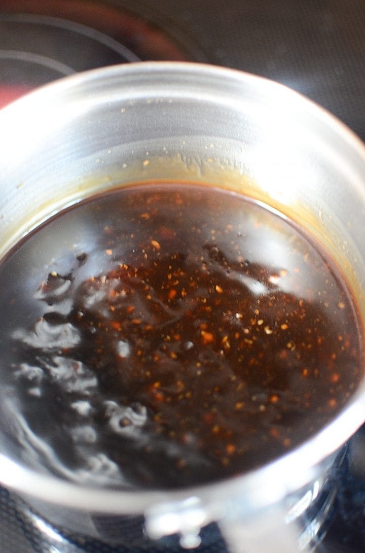 closer look at sticky marinade simmering on stove 