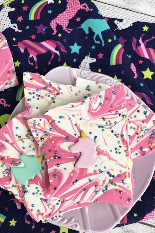 Pink and white swirled unicorn bark on a purple plate. 