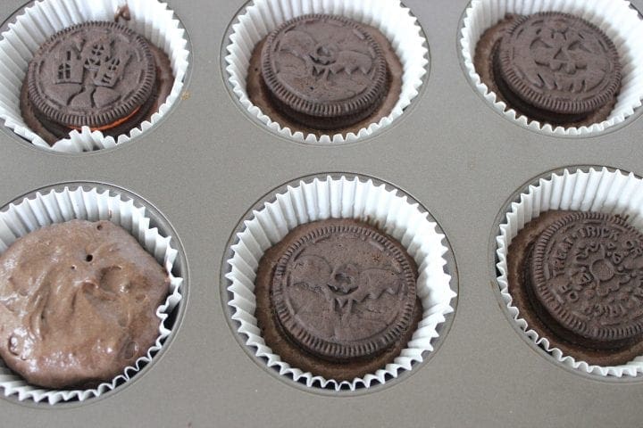 putting cupcakes in cups and then adding cookies