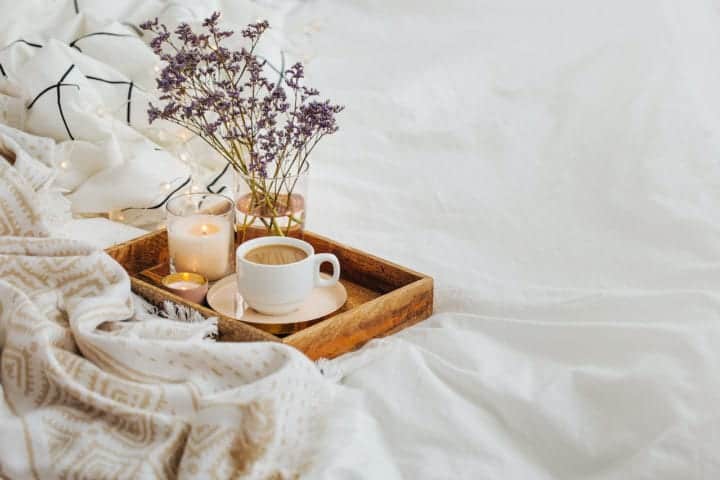 flowers candle coffee wood tray on bed