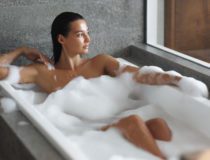 Luxury Spa and Bathing of Young Woman in Bathtub Indoors at Bathroom