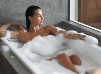 Luxury Spa and Bathing of Young Woman in Bathtub Indoors at Bathroom