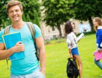 Handsome man student in a city park on summer day