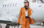 Conception of tourism Passenger woman that is in yellow clothes and sunglasses