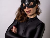 Sexy young woman with black bodysuit and cat mask