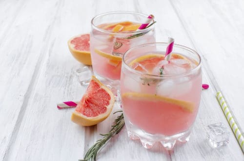 Cocktail with grapefruit slice on a wooden table