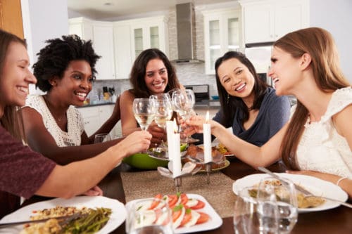 Group Of Female Friends Enjoying Dinner Party At Home