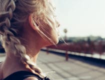 Young woman with braided pigtails Soft sunny colors