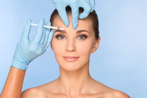 Beauty woman giving botox injections