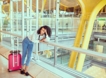 Woman sad and unhappy at the airport with flight canceled