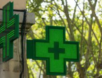 Closeup of a green pharmacy sign outside a pharmacy store in France