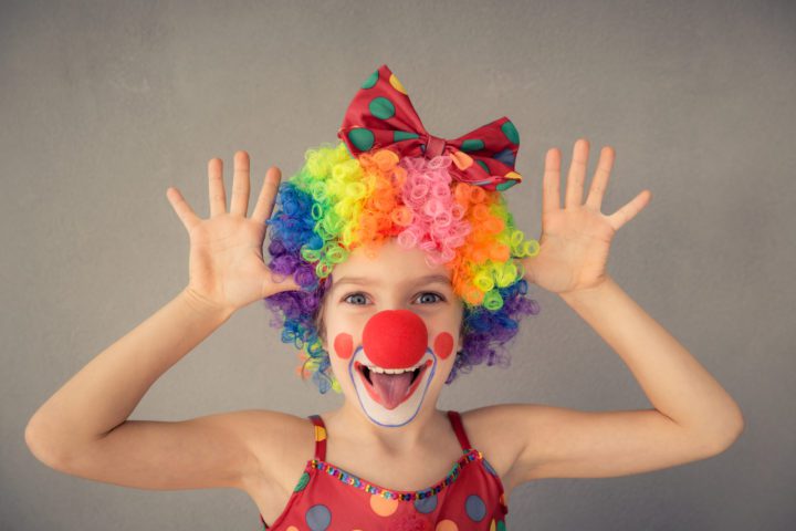 Funny kid clown playing indoor