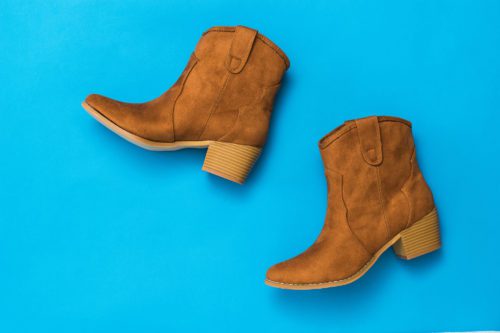 A pair of women's suede shoes on a blue background